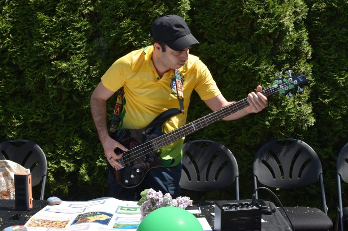 Gustavo playing guitar at the Brazil station